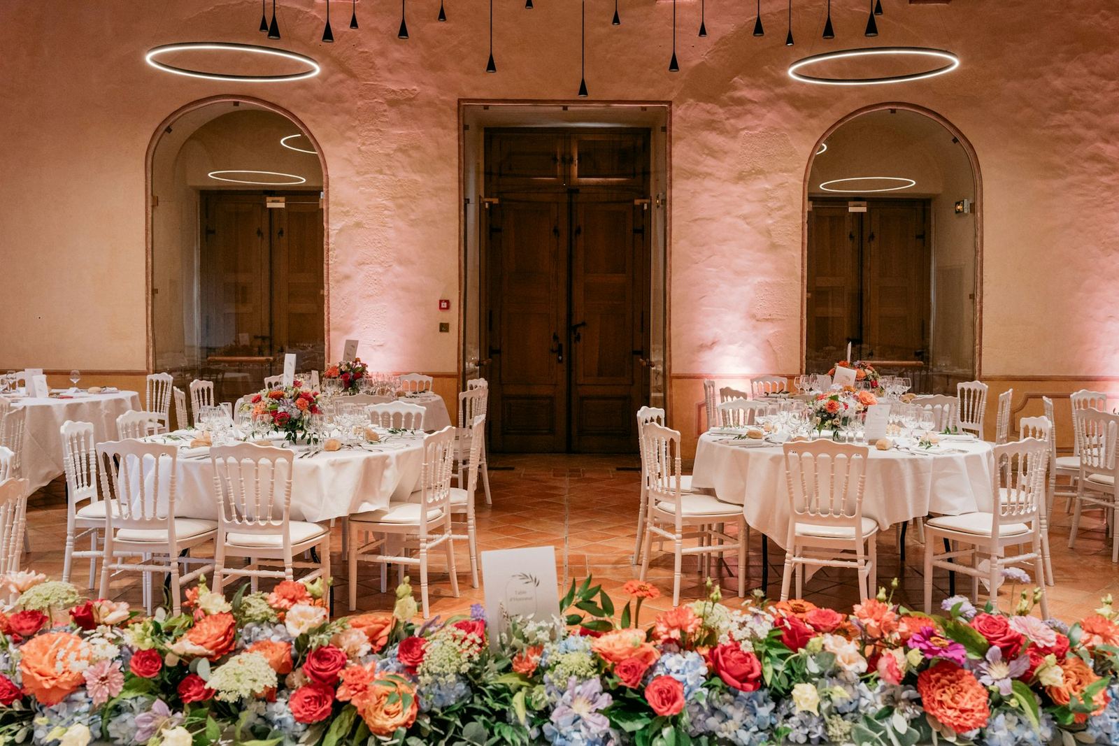 A long table dressed with candles and flowers.